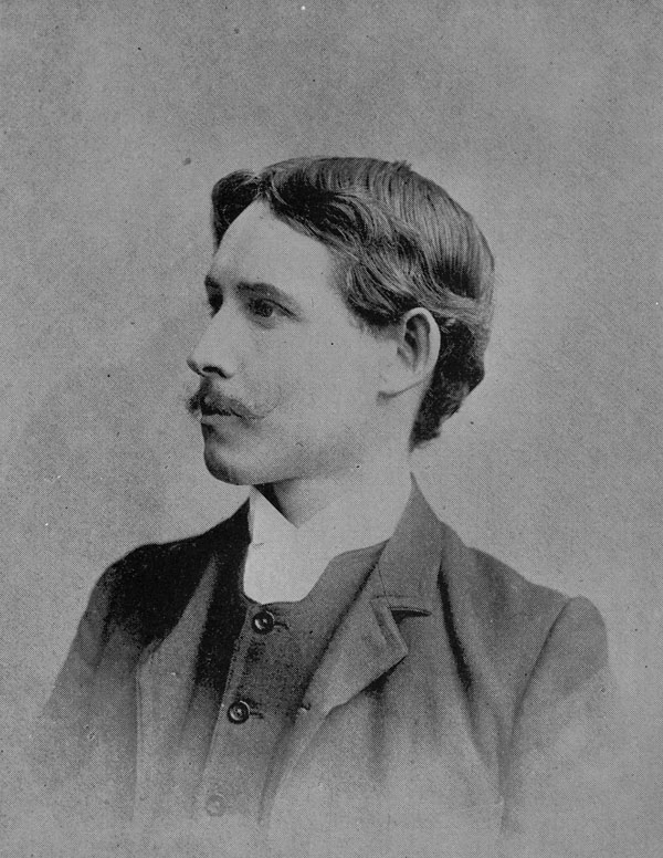 a black and white image of Archibald Lampman with a neat mustache and wearing a dark suit with a white collar.